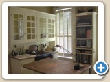 Kitchen with antique glass door cabinets and Thailand teak island